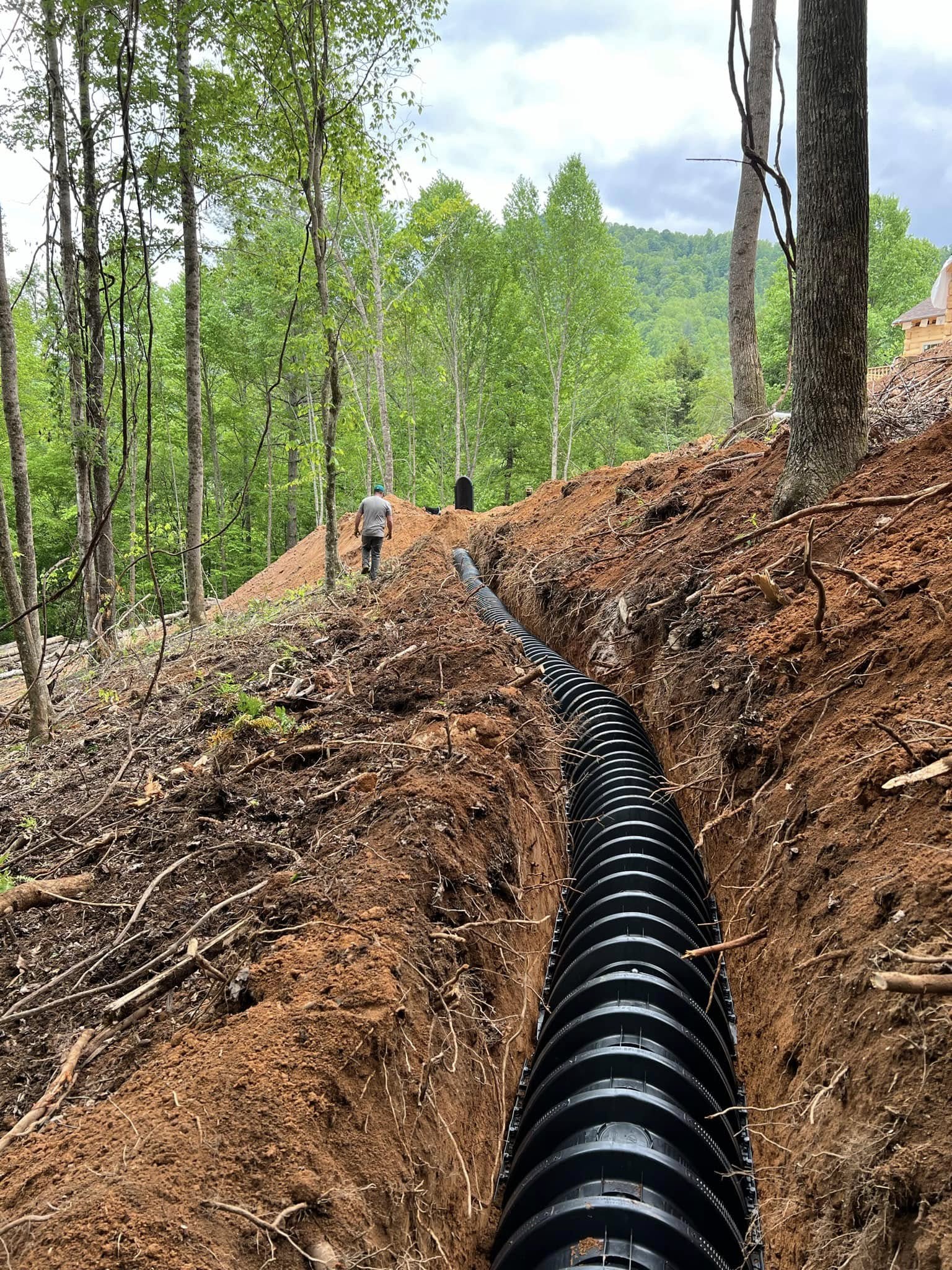 Drainage line run down a slope to control runoff and erosion, Western NC