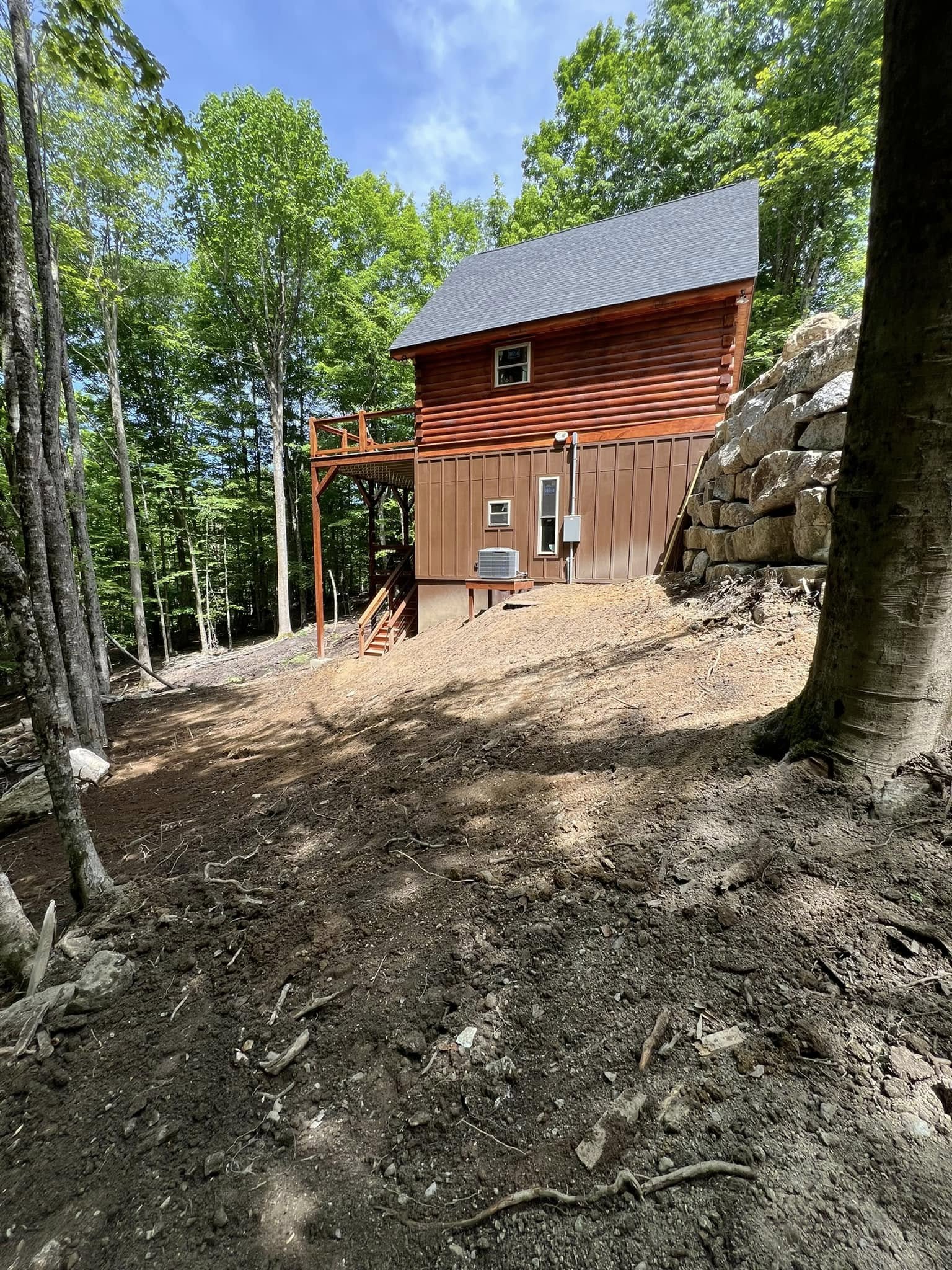 Site regraded around a finished home after septic and drainage work near Burnsville, NC